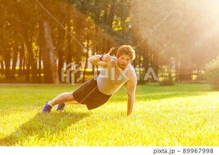 Redhead and bearded athlete thumbs up and looking at camera. Summertime 89967998