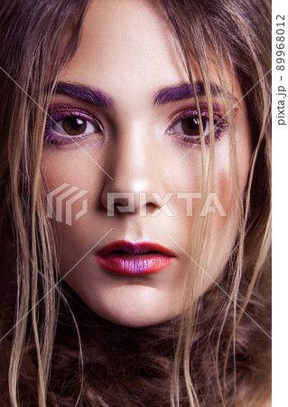 Closeup of beautiful fashion model with makeup and hairstyle on her face. Studio shot, looking at camera..retouched with special care and attention. 89968012