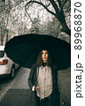 Emotional portrait, girl with umbrella, emotion - reaction to surprise, fright 89968870