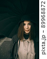 Emotional portrait, girl with umbrella, emotion - reaction to surprise, fright 89968872