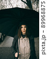Emotional portrait, girl with umbrella, emotion - reaction to surprise, fright 89968875