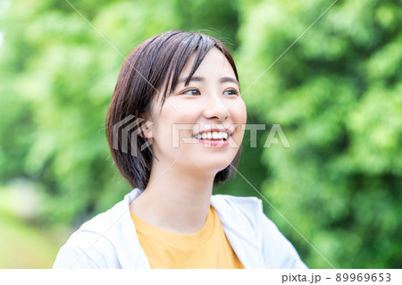 新緑でリフレッシュする笑顔の若い女性 89969653