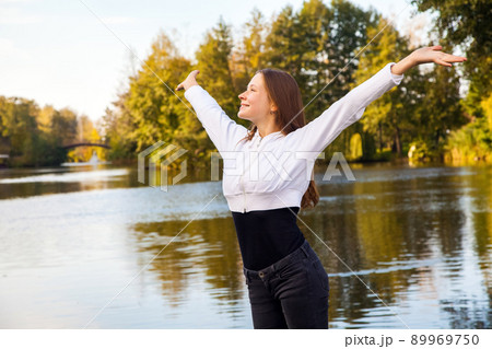 Happiness girl in the park. Autumn, fallen leaves. 89969750