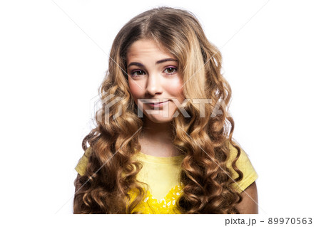 Portrait of happy girl with wavy hairstyle and yellow t shirt. studio shot isolated on white background. Portrait of happy girl with wavy hairstyle and yellow t shirt. studio shot isolated on white background. 89970563