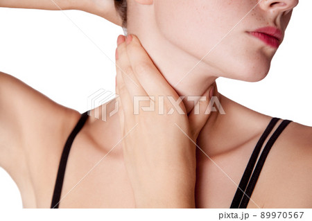 Closeup view of a young woman with pain on neck or thyroid gland on white background. Closeup view of a young woman with pain on neck or thyroid gland on white background. 89970567