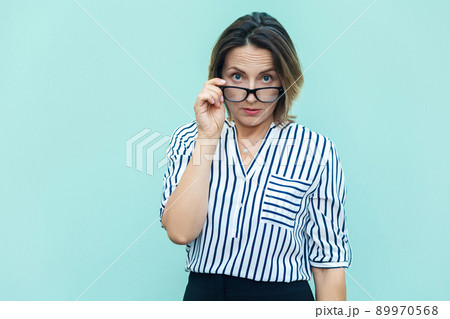 What did you say? Seriosly blonde busines woman and boss with glass looking at camera. Studio shot What did you say? Seriosly blonde busines woman and boss with glass looking at camera. Studio shot 89970568