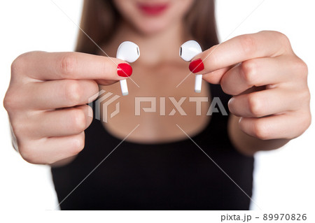 Wireless earphones on human hands. studio shot. 89970826