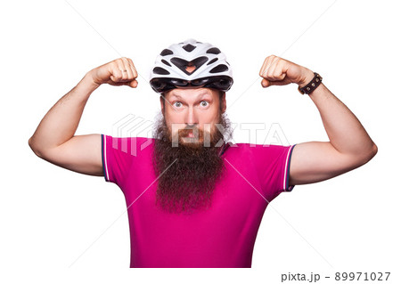 funny happy european bearded cyclist wearing helmet with pink or purple t shirt. advise people to protection. studio shot. isolated on white. funny happy european bearded cyclist wearing helmet with pink or purple t shirt. advise people to protection. studio shot. isolated on white. 89971027
