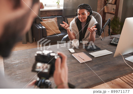 Unrecognizable man holding camera helping modern female influencer with shooting content for her blog Unrecognizable man holding camera helping modern female influencer with shooting content for her blog 89971177