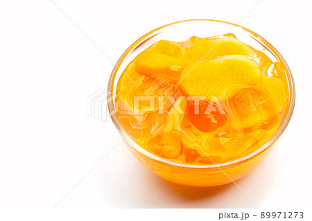 Marian plum fruits in syrup with ice in glass bowl on white Marian plum fruits in syrup with ice in glass bowl on white 89971273