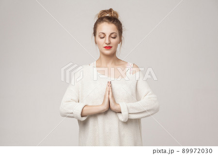 Blone young adult woman closed up, relax and pray. Studio shot Blone young adult woman closed up, relax and pray. Studio shot 89972030