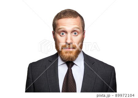 Shocked surprised businessman looking at camera with big eyes. isolated on white, looking at camera. 89972104