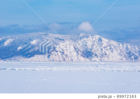 Frozen surface of Baikal lake at sunset. 89972163