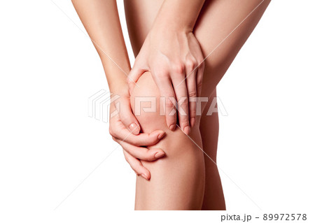 Closeup view of a young woman with knee pain on white background. 89972578