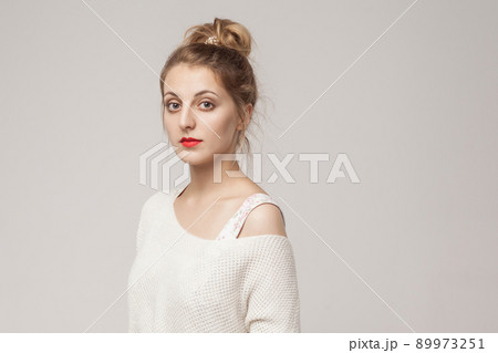 Portrait of cute georgian woman, looking at camera with relax face. Studio shot, gray background Portrait of cute georgian woman, looking at camera with relax face. Studio shot, gray background 89973251