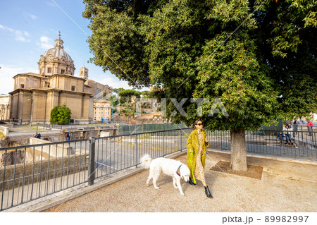 Woman walks with her dog in the centre of Rome Woman walks with her dog in the centre of Rome 89982997
