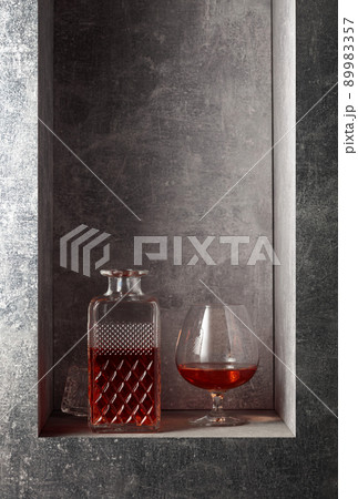 Glass and decanter of brandy. Glass and decanter of brandy. 89983357