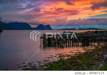 Colorful sunset over a Wooden jetty on Senja Island in Norway 89987124