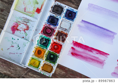 Watercolor paints, palette and paper Watercolor paints, palette and paper 89987863