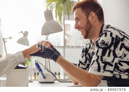 Experienced nail technician working in modern manicure salon 89987978