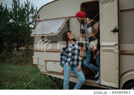 Romantic couple spending time together near trailer home. 89989963