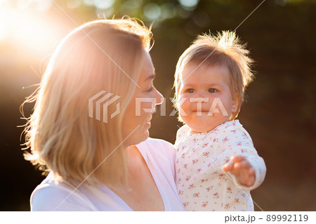 Portraits of smiling mother hugging her cute baby. Concept of happy childhood 89992119