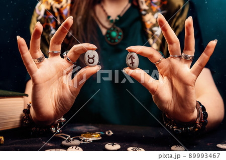 Astrology and horoscope. Female's holds stones with the zodiac sign of Taurus and Sagittarius. The concept of compatibility of partners according to the signs of the zodiac Astrology and horoscope. Female's holds stones with the zodiac sign of Taurus and Sagittarius. The concept of compatibility of partners according to the signs of the zodiac 89993467