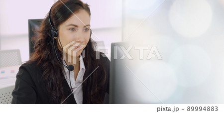 Business people wearing headset working in office broaden view Business people wearing headset working in office broaden view 89994883