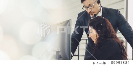 Business people wearing headset working in office broaden view 89995384