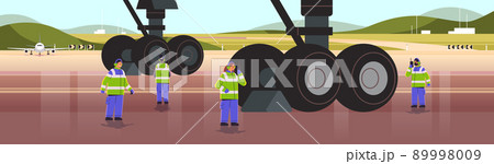 aviation marshallers in uniform using walkie talkie air traffic controllers airline worker in signal vests professional airport staff aviation marshallers in uniform using walkie talkie air traffic controllers airline worker in signal vests professional airport staff 89998009