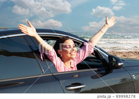 Happy woman out window car against blue sky Happy woman out window car against blue sky 89998278