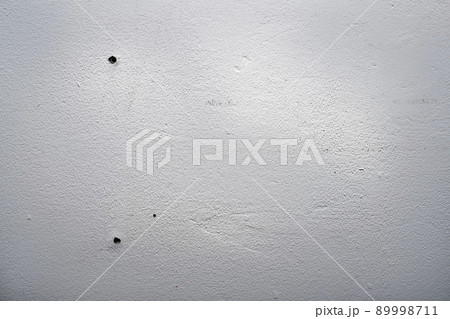 Hole and dowels in an old dirty white wall. Hole and dowels in an old dirty white wall. 89998711