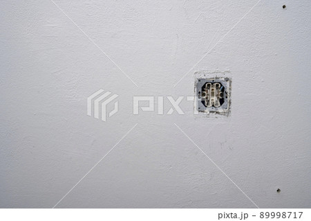 Opened old socket on an old dirty white wall. Repair in an old apartment and relocation of outlets. 89998717