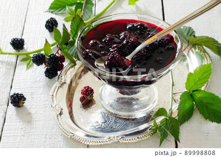 Blackberries, canned in juice on a wooden table Blackberries, canned in juice on a wooden table 89998808