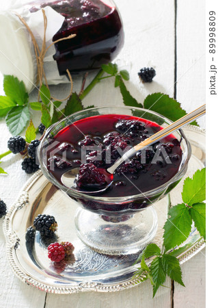 Blackberries, canned in juice cans on a wooden table Blackberries, canned in juice cans on a wooden table 89998809
