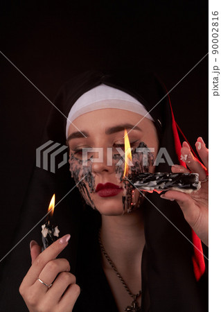Vertical shot portrait of a young girl with face stained in candle wax. 90002816