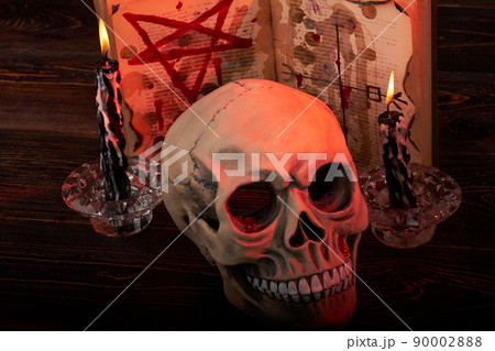 Close-up humans skull with candles and bible with pentagram. Close-up humans skull with candles and bible with pentagram. 90002888