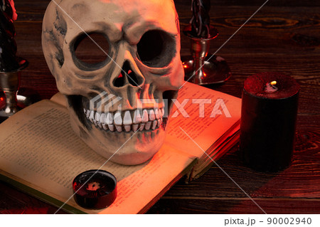 Wicca satanic ritual concept. Humans skull on the satanic bible book. Wicca satanic ritual concept. Humans skull on the satanic bible book. 90002940
