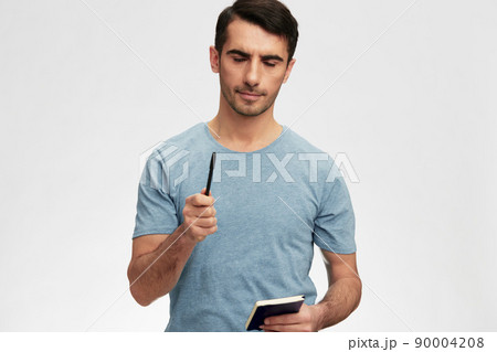 man with a notepad in hand casual wear posing emotions isolated background man with a notepad in hand casual wear posing emotions isolated background 90004208