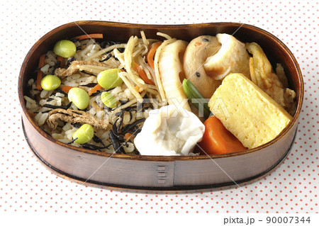ひじきと枝豆のご飯、シュウマイや玉子焼き、煮物等たくさんのおかずが入っている幕の内弁当を俯瞰で撮影 ひじきと枝豆のご飯、シュウマイや玉子焼き、煮物等たくさんのおかずが入っている幕の内弁当を俯瞰で撮影 90007344
