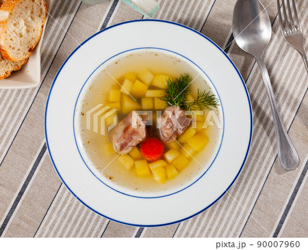 Rustic style soup in meat stock with pork and vegetables Rustic style soup in meat stock with pork and vegetables 90007960