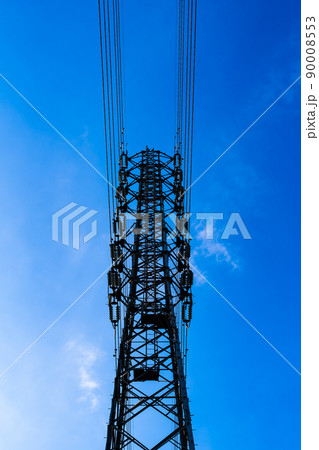 見上げる送電鉄塔の上部と高圧線と雲が少ない青空 タテ 高彩度コントラスト 見上げる送電鉄塔の上部と高圧線と雲が少ない青空 タテ 高彩度コントラスト 90008553