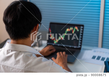 Overwork Concept The office employee working at the office by analyzing the graph on his laptop screen Overwork Concept The office employee working at the office by analyzing the graph on his laptop screen 90008675