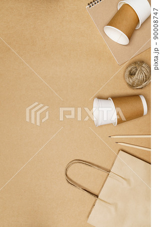 Eco friendly concept, Paper bag with cup and notebook pencil with jute rope on wooden background Eco friendly concept, Paper bag with cup and notebook pencil with jute rope on wooden background 90008747