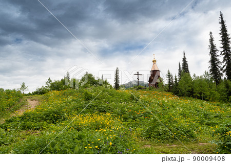 Golden domes of Orthodox Church and cross in taiga forest. Appeal to God, prayer before difficult tourist route. Salvation of soul in pristine nature 90009408