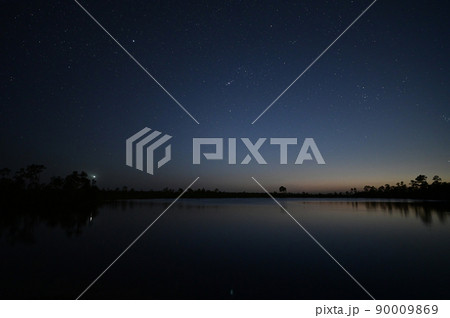 Stars at twilight over Pine Glades Lake in Everglades National Park, Florida. 90009869