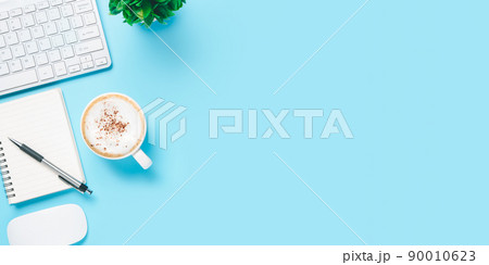 Blue office desk with computer keyboard, notebook, pen and cup of coffee, Top view wth copy space, Flat lay.. 90010623