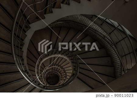 The spiral staircase detail in a beautiful of the building. 90011023