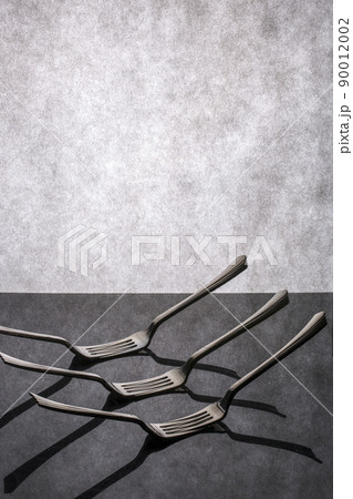 Very simple still life with forks on gray background Very simple still life with forks on gray background 90012002