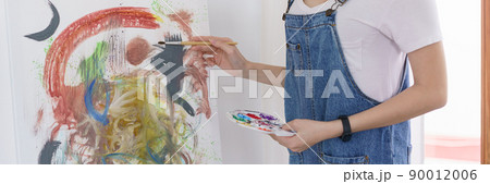 Creative of art concept, Young asian woman use paintbrush with color palette to drawing the artwork Creative of art concept, Young asian woman use paintbrush with color palette to drawing the artwork 90012006
